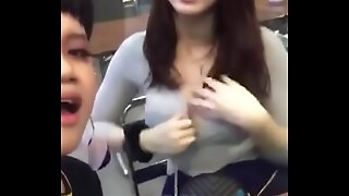 Thai girl gets her boob exposed in public